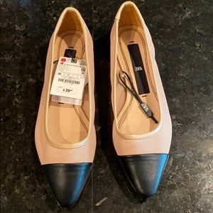 Tan and black pointed toe flats